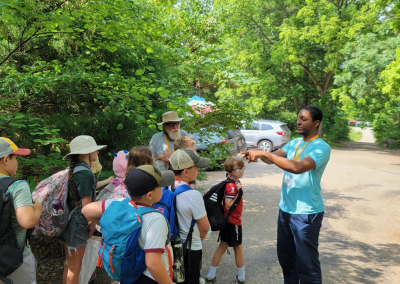 Na'im pointing out insect behaviors